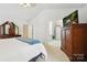 Bright bedroom featuring a walk-in shower, vaulted ceilings, and coordinated furnishings at 8217 Lansford Rd, Charlotte, NC 28277