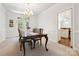 Formal dining room with stylish chandelier and a view of the patio through French doors at 8217 Lansford Rd, Charlotte, NC 28277