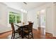 Sunlit dining area features hardwood floors and a large window with wooded views at 8217 Lansford Rd, Charlotte, NC 28277