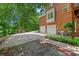 Stunning brick home exterior featuring a two-car garage, complemented by a lush green lawn and mature trees at 8217 Lansford Rd, Charlotte, NC 28277