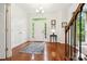 Bright foyer featuring hardwood floors, white walls, and a front door with sidelights at 8217 Lansford Rd, Charlotte, NC 28277