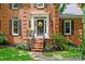 Close-up of the front door with a wreath and brick steps leading to the entrance at 8217 Lansford Rd, Charlotte, NC 28277