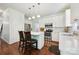Updated kitchen with white cabinets, stainless steel appliances, and a center island with seating at 8217 Lansford Rd, Charlotte, NC 28277