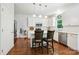 Bright kitchen with stainless appliances, white cabinets, and hardwood flooring at 8217 Lansford Rd, Charlotte, NC 28277