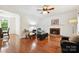 Bright living room featuring a fireplace, hardwood floors, and views into the kitchen and dining area at 8217 Lansford Rd, Charlotte, NC 28277