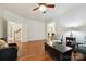 Spacious living room featuring hardwood floors, white walls, and a ceiling fan at 8217 Lansford Rd, Charlotte, NC 28277