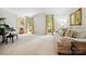 Inviting living room with carpet, piano, and ample natural light from large windows at 8217 Lansford Rd, Charlotte, NC 28277