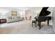 Cozy living room with neutral carpet, piano, and comfortable seating arrangement at 8217 Lansford Rd, Charlotte, NC 28277