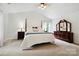 Spacious main bedroom with hardwood furniture and natural light at 8217 Lansford Rd, Charlotte, NC 28277