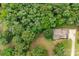 Aerial shot showcases property's home, roof, driveway and private wooded setting at 8622 Lower Rocky River Rd, Concord, NC 28025