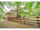 Inviting home featuring a spacious, fenced backyard with mature trees offering shade and privacy at 8622 Lower Rocky River Rd, Concord, NC 28025