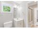 Bathroom with white vanity, toilet, mirror, and shower-tub combo at 8622 Lower Rocky River Rd, Concord, NC 28025
