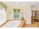 Bathroom featuring a jetted tub, green accents, and a glass-enclosed shower at 8622 Lower Rocky River Rd, Concord, NC 28025