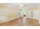 Bright bedroom featuring wood-look floors, two windows, and closet and bathroom access at 8622 Lower Rocky River Rd, Concord, NC 28025