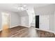 Neutral bedroom featuring wood flooring, two closets, window seat, and updated light fixture at 8622 Lower Rocky River Rd, Concord, NC 28025