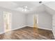 Spacious bedroom with hardwood floors, a ceiling fan and two doorways at 8622 Lower Rocky River Rd, Concord, NC 28025
