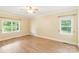 Spacious bedroom with natural light, ceiling fan, and wood-look floors at 8622 Lower Rocky River Rd, Concord, NC 28025