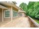 Large, wood deck overlooking the exterior of the home and large, green trees at 8622 Lower Rocky River Rd, Concord, NC 28025