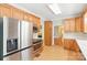 Bright kitchen showcasing stainless steel refrigerator, oven and ample wood cabinet space at 8622 Lower Rocky River Rd, Concord, NC 28025