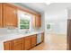 Bright kitchen featuring wood cabinets, white countertops, and modern stainless steel appliances at 8622 Lower Rocky River Rd, Concord, NC 28025