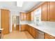 Charming kitchen with wood cabinets, stainless steel dishwasher and sink beneath a bright window at 8622 Lower Rocky River Rd, Concord, NC 28025