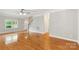 Inviting living room featuring hardwood floors, staircase, and great natural light at 8622 Lower Rocky River Rd, Concord, NC 28025