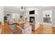 Bright living room featuring hardwood floors, fireplace, ceiling fan and a view into the dining area at 8622 Lower Rocky River Rd, Concord, NC 28025
