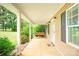 Inviting covered front porch with a swing, offering a relaxing outdoor space at 8622 Lower Rocky River Rd, Concord, NC 28025