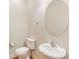 Classic half bathroom featuring a pedestal sink, toilet, and an oval mirror at 8622 Lower Rocky River Rd, Concord, NC 28025