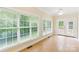 Sunroom featuring multiple windows, tile floor, and double french doors at 8622 Lower Rocky River Rd, Concord, NC 28025