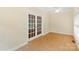 Sunroom with tile floor, many windows, and double french doors at 8622 Lower Rocky River Rd, Concord, NC 28025