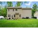 Back of house with a patio, seating, large lawn, and mature trees at 9856 Caldwell Depot Rd, Cornelius, NC 28031