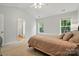 Comfortable bedroom featuring plush carpeting, neutral walls, and natural light from two windows at 9856 Caldwell Depot Rd, Cornelius, NC 28031