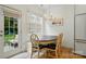 Charming dining area with wood floors, a modern chandelier, and a view of the outdoor space at 9856 Caldwell Depot Rd, Cornelius, NC 28031