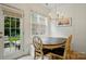 Bright dining area with wooden table and chairs, natural light, and view to the backyard at 9856 Caldwell Depot Rd, Cornelius, NC 28031