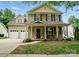 Charming two-story home with a welcoming front porch and well-manicured landscaping at 9856 Caldwell Depot Rd, Cornelius, NC 28031
