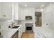 Updated kitchen with stainless steel appliances, white cabinetry, and an island for food prep at 9856 Caldwell Depot Rd, Cornelius, NC 28031