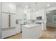 Bright, white kitchen featuring an island, stainless steel appliances, and modern pendant lighting at 9856 Caldwell Depot Rd, Cornelius, NC 28031