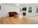 Spacious living room with hardwood floors, fireplace, and large windows showcasing backyard views at 9856 Caldwell Depot Rd, Cornelius, NC 28031
