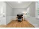 Home office with natural light, wainscoting, and hardwood floors at 9856 Caldwell Depot Rd, Cornelius, NC 28031