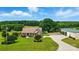 Picturesque aerial view of a home with a large, well-maintained lawn, a long driveway and mature trees at 9950 Foil Rd, Mount Pleasant, NC 28124