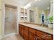 Bathroom with double sinks, granite countertop, walk-in shower, and linen closet at 9950 Foil Rd, Mount Pleasant, NC 28124