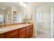 Bathroom with double sinks, granite countertop, and a separate toilet room at 9950 Foil Rd, Mount Pleasant, NC 28124