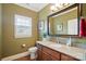 Bathroom with granite vanity, framed mirror, tiled floor, and window with shutters at 9950 Foil Rd, Mount Pleasant, NC 28124