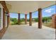 Large covered patio with brick columns, offering a view of the backyard and mature landscaping at 9950 Foil Rd, Mount Pleasant, NC 28124