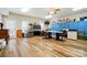 Spacious craft room featuring wood flooring, storage cabinets, and a large work area with great natural light at 9950 Foil Rd, Mount Pleasant, NC 28124