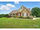 Beautiful single-story home with a mix of brick and stone facade with well-manicured landscaping at 9950 Foil Rd, Mount Pleasant, NC 28124