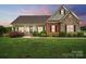 Charming home featuring a beautiful landscaped yard and a mix of brick and stone facade, perfect for curb appeal at 9950 Foil Rd, Mount Pleasant, NC 28124