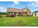 Charming home featuring a brick and stone exterior, a covered porch, and a manicured lawn at 9950 Foil Rd, Mount Pleasant, NC 28124