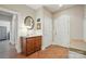 Hallway with a console table, mirror, tile floors, and white paneled doors at 9950 Foil Rd, Mount Pleasant, NC 28124